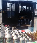 A horse drawn wagon filled with delicious maple syrup for sale